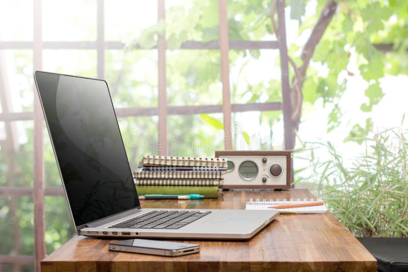 Laptop on wooden worktable stock photo. Image of wooden 73337468