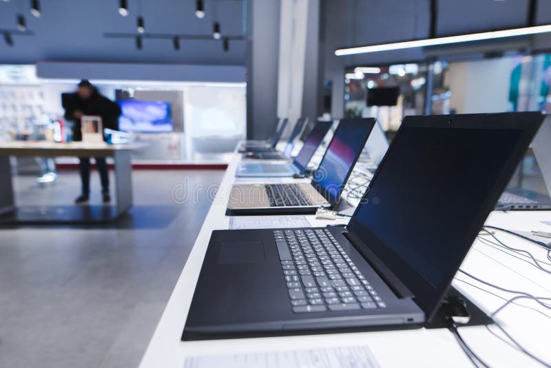 Laptops on the table in the electronics store. The department of laptops in the tech store. Buy a laptop