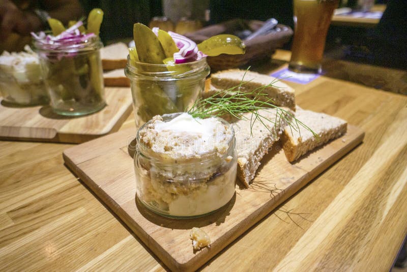 Lard with cracklings served with bread, sour cucumbers and red onions