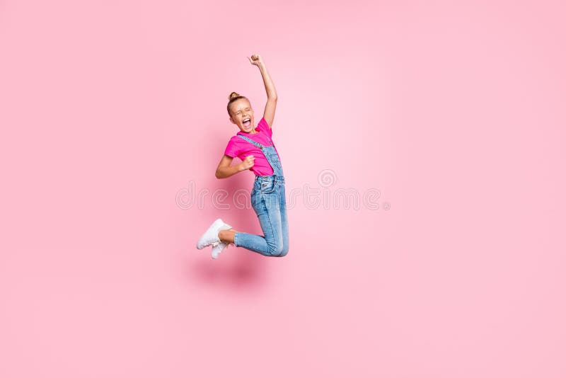 Larga foto de tamaño corporal de una alegre y moderna chica extática regocijándose con la victoria saltando loca aislada sobre foto de archivo Larga foto de tamaño corporal de una alegre y moderna chica extática regocijándose con la victoria saltando loca aislada sobre foto de archivo