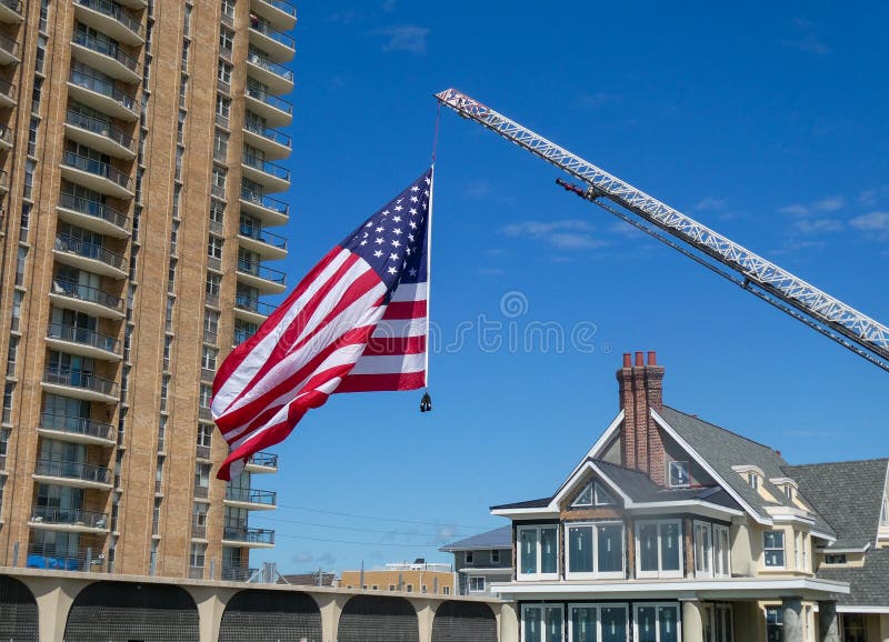 Large American Flag Handing from a Fire Truck Ladder Weighed Down by ...