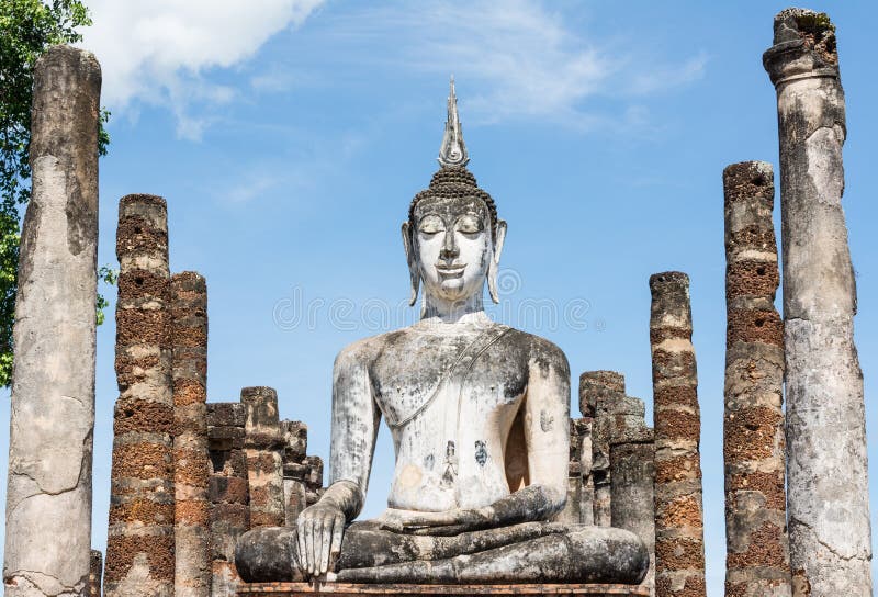 Large ancient white Buddha image and pillars stock image