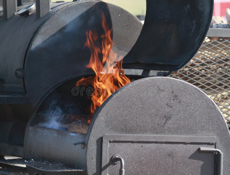 Large BBQ smoker with flames