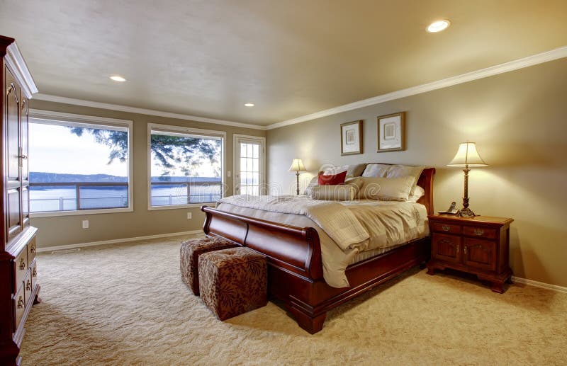 Large Bedroom with Wood Bed and Water View. Stock Photo Image of furnished, house 25498472