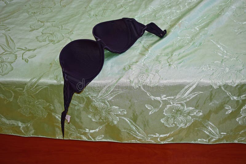 A Large Black Bra Lying on the Bed Stock Photo - Image of bikini