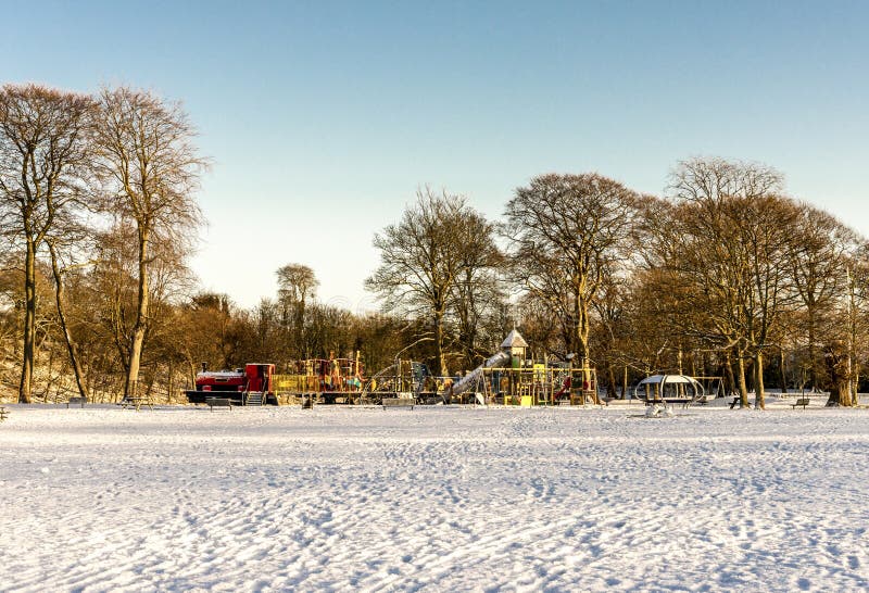 Large children playground covered by snow in Seaton Park, Aberdeen, Scotland