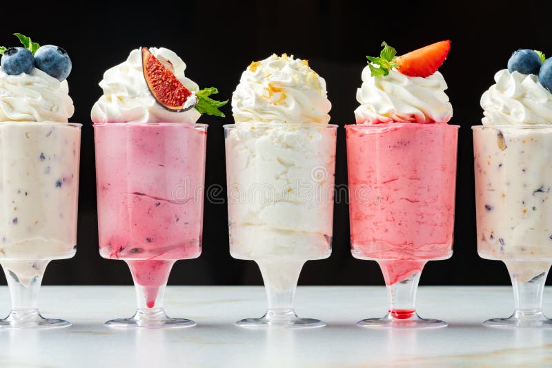 Large Collection of Mousse Desserts in Glasses for Catering Stock Photo