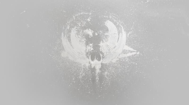 Large color stain in the shape of an angel on the studio floor after throwing white paint on the model, copy space royalty free illustration