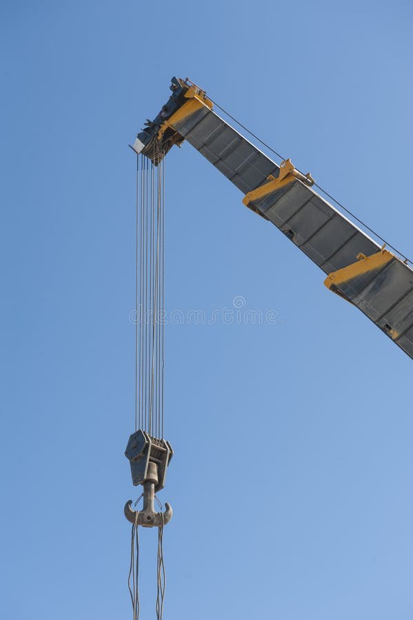 Large crane jib against blue sky background