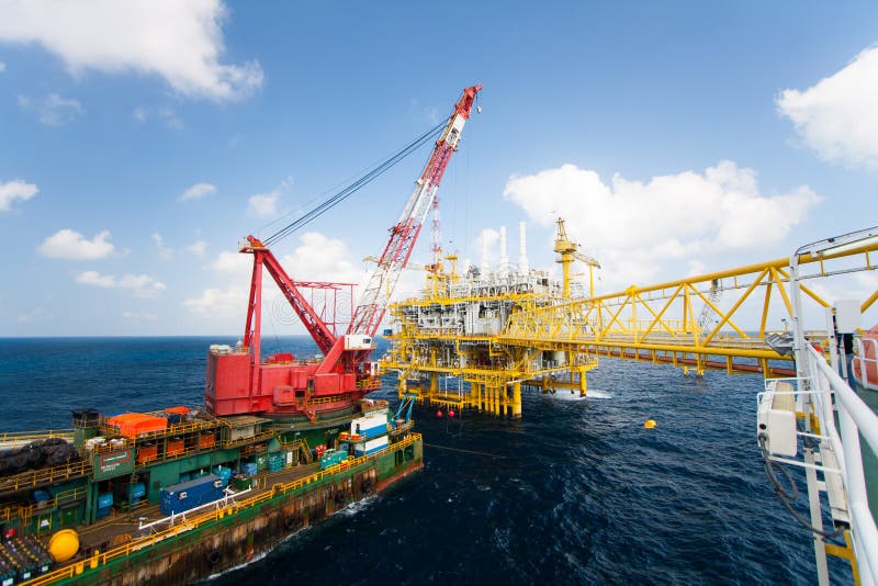 Large crane vessel installing the platform in offshore,crane barge doing marine heavy lift installation works stock photography