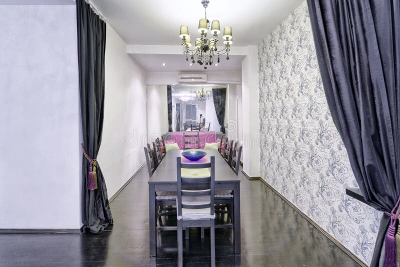 Large dining table in the interior of the house. stock images