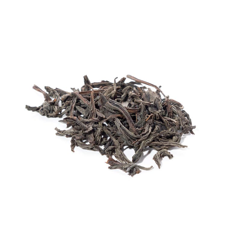 Large Dried Black Tea Leaves Piled on a White Background. Stock Photo