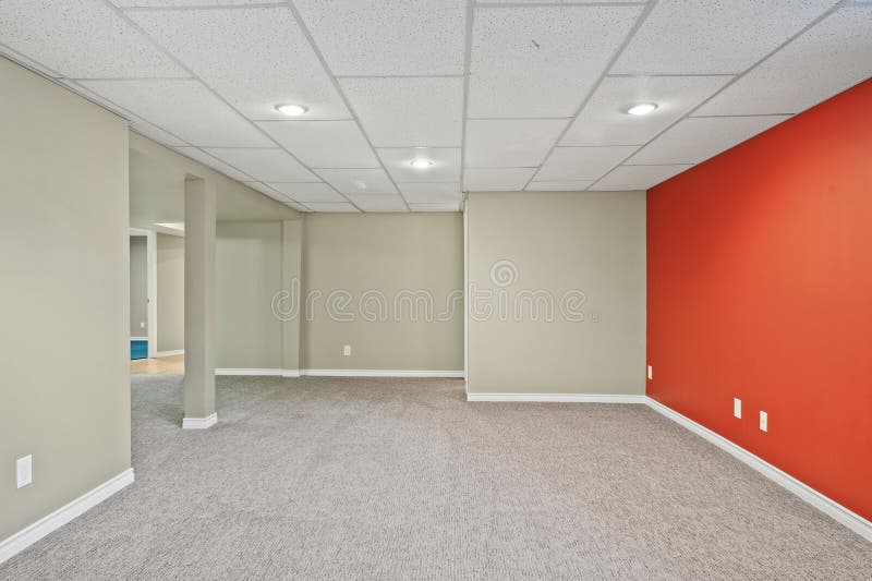 Large empty room with a red wall and white ceiling royalty free stock photos