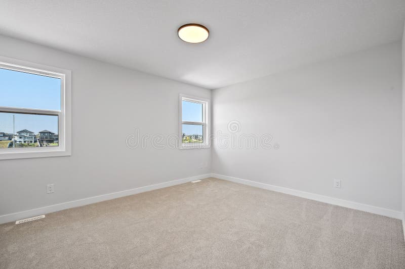 Large, empty room with a white ceiling and white walls royalty free stock images