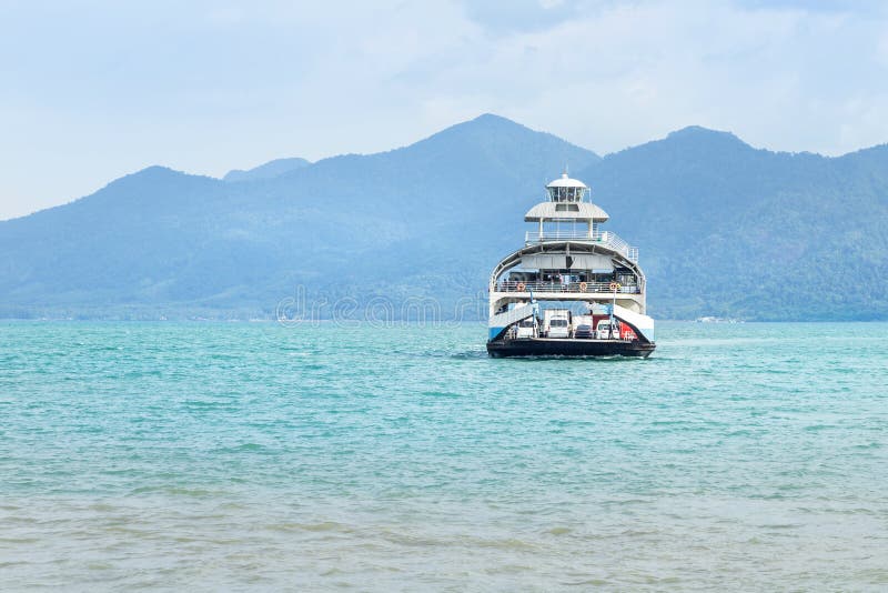 Large ferryboat carrying passengers and cars crossing in blue sea between Koh Chang island and Trad province, Thailand royalty free stock image Large ferryboat carrying passengers and cars crossing in blue sea between Koh Chang island and Trad province, Thailand royalty free stock image