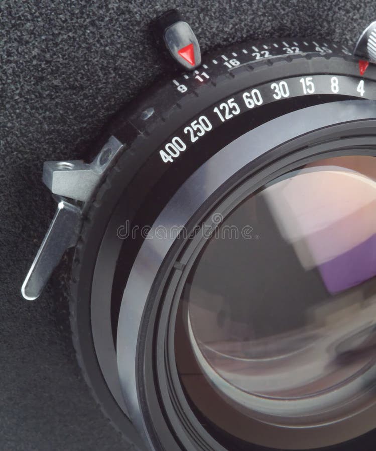 Large format camera lens in macro. Large format camera lens, macro shot of lens and shutter on lensboard stock photos Large format camera lens in macro. Large format camera lens, macro shot of lens and shutter on lensboard stock photos