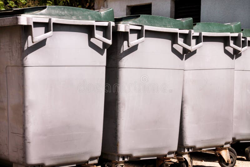 Large garbage containers, trash dumpsters and bins standing in row. Orderly stowed garbage cans. stock image Large garbage containers, trash dumpsters and bins standing in row. Orderly stowed garbage cans. stock image