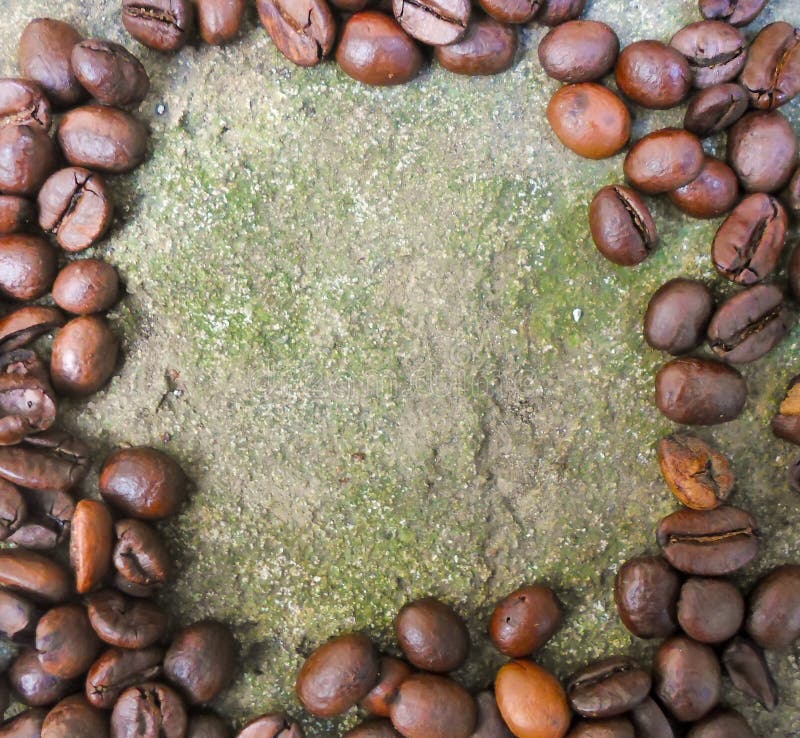 Large Grains of Coffee on a Concrete Surface. Broken and Whole Coffee