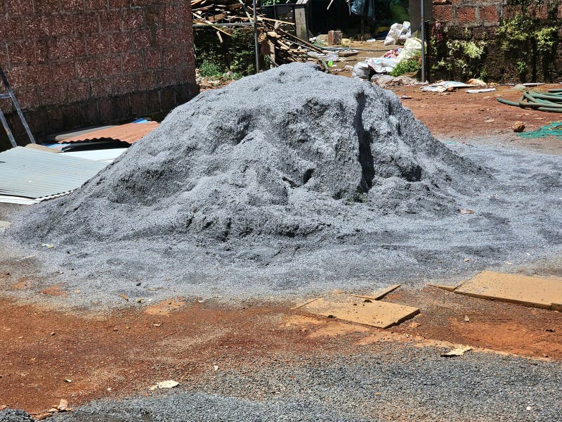 A large, gray mound of construction aggregate, likely crushed stone or metal royalty free stock photo