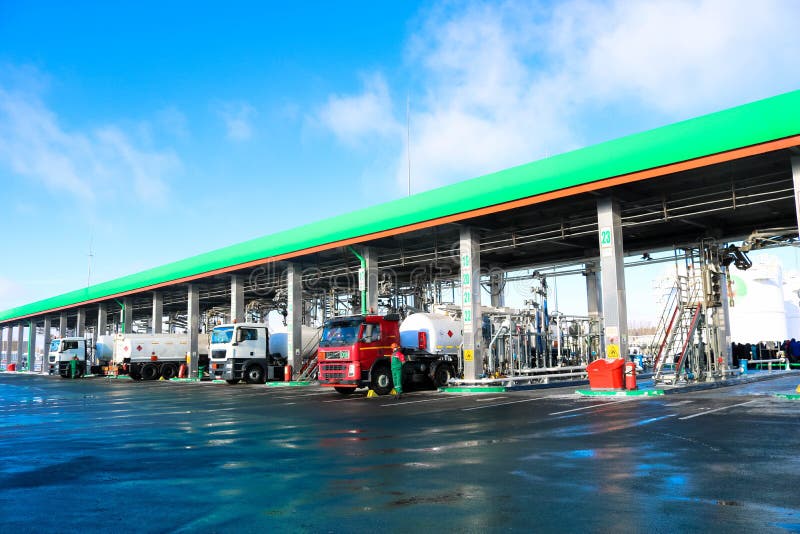 Large green industrial gas station for refueling vehicles, trucks and tanks with fuel, gasoline and diesel in the winter.