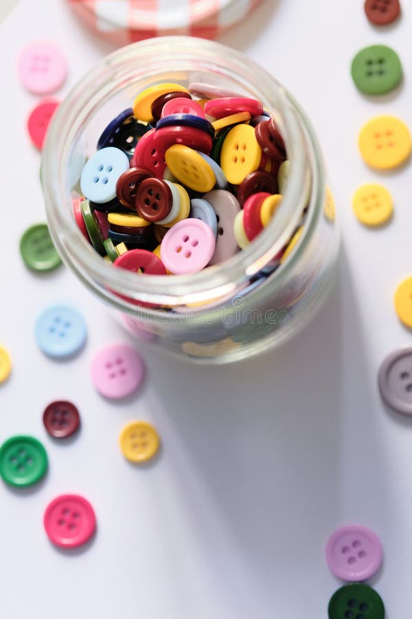 Large Group of Colorful Plastic Sewing Buttons on Table Stock Image