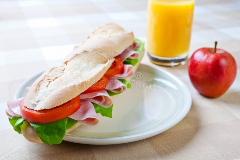 A large ham and tomato baguette