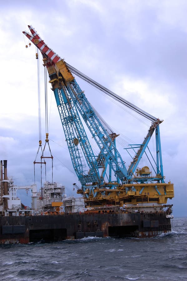 Large Heavy lift crane observed in operation in North Sea, lifting a large topside of a new platform into place on top of a jacket. Large Heavy lift crane observed in operation in North Sea, lifting a large topside of a new platform into place on top of a jacket.