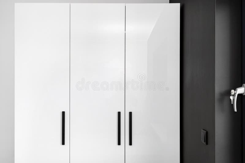 Large and High Wardrobe in the Bedroom with White Fronts and Black