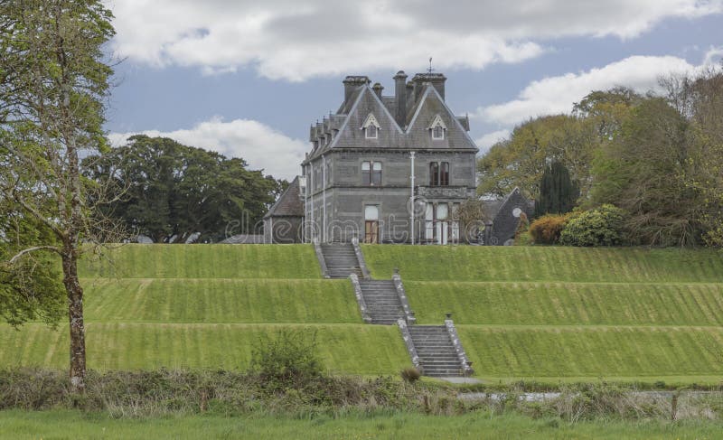 Large house on the top of a hill with steps royalty free stock photo