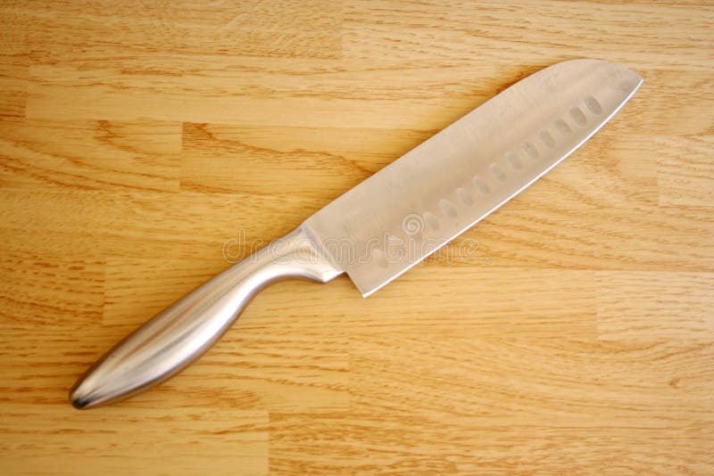 Large knife on a butcher block table