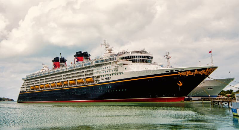 Large luxury cruise ship Disney Wonder on sea water and cloudy sky background docked at port of Nassau, Bahamas