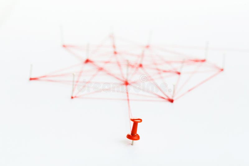 A large mesh of pins tied together with a red cord. Communication, network concept