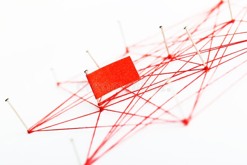 A large mesh of pins tied together with a red cord. Communication, network concept. A large mesh of pins connected with a cord. Communication, network concept
