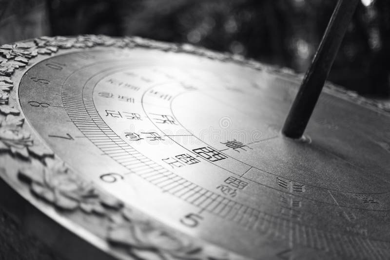 Large metal sundial with Chinese characters.