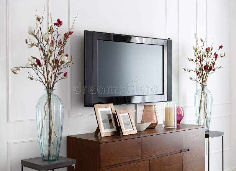 Large modern TV on a white wall in the interior of the room