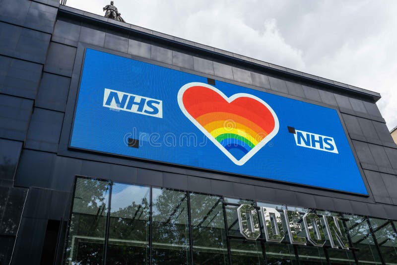 A Large NHS Electronic Billboard on the Side of the Odeon Cinema in  Leicester Square with a Statue of Batman on the Roof Editorial Photo -  Image of electronic, blue: 187148491