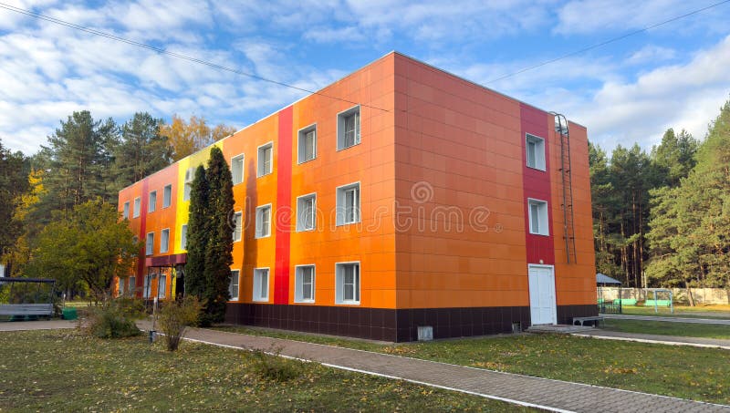 A large orange building with a red stripe stock photography