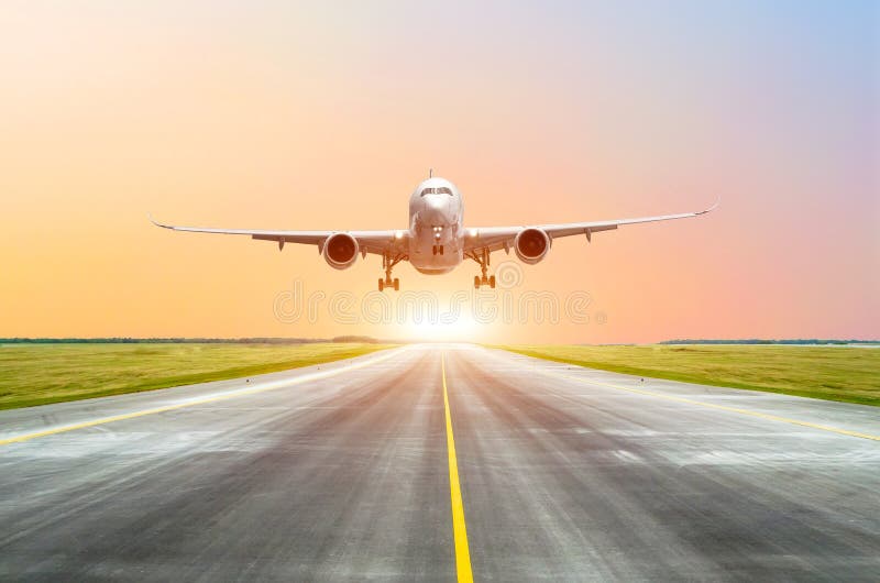 Large passenger plane take off from the runway before the light from the sunshine.