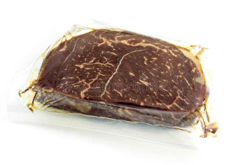 A large piece of beef, steak Packed in vacuum packaging on a white background royalty free stock photography A large piece of beef, steak Packed in vacuum packaging on a white background royalty free stock photography