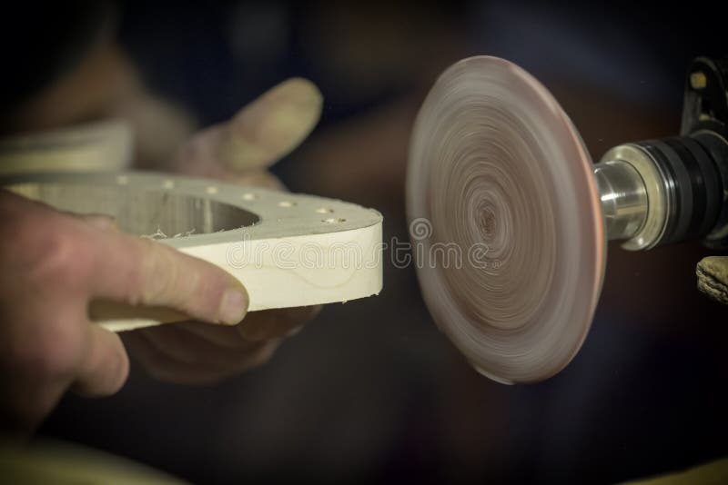 A large plan, hands of an artisan working on a wooden part stock photography A large plan, hands of an artisan working on a wooden part stock photography