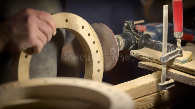 A large plan, hands of an artisan working on a wooden part royalty free stock image A large plan, hands of an artisan working on a wooden part royalty free stock image