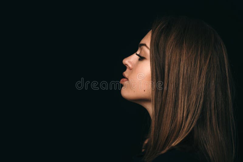 Large Portrait of the Girl`s Profile. Girl`s Face on a Black