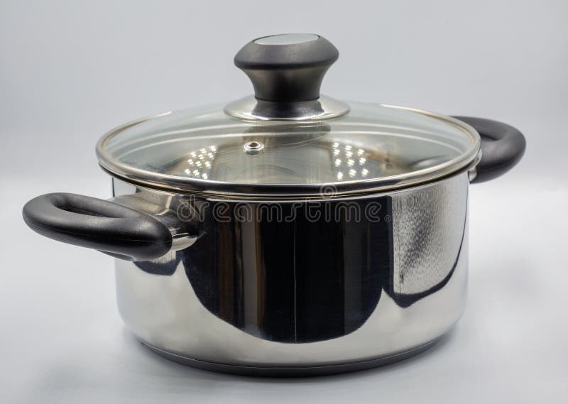 Studio shoot of large shiny stainless steel empty new saucepan closeup on white. Traditional big metal pot stock images, royalty-free photos and pictures
