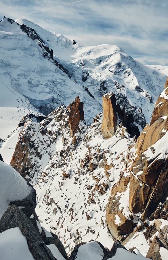 Climbers look very small at the foot of Mont Blanc. Mountain landscape in the Alps, France. Climbers look very small at the foot of Mont Blanc. Mountain landscape in the Alps, France