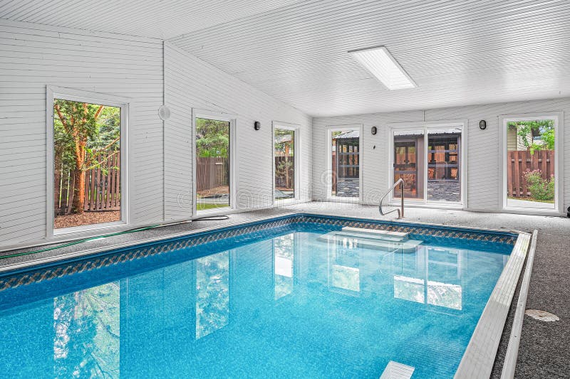 Large swimming pool with a white ceiling and a white wall stock photography