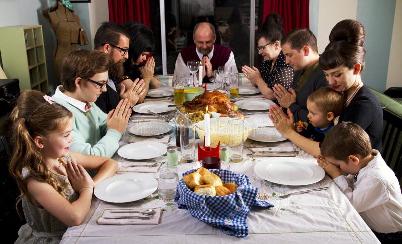 Large family celebrates Thanksgiving dinner with prayer. Large family celebrates Thanksgiving dinner with prayer