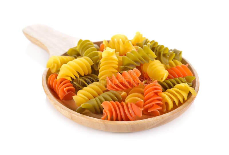 Large vegeroni Rotini spirals pasta in wooden plate on white stock photos