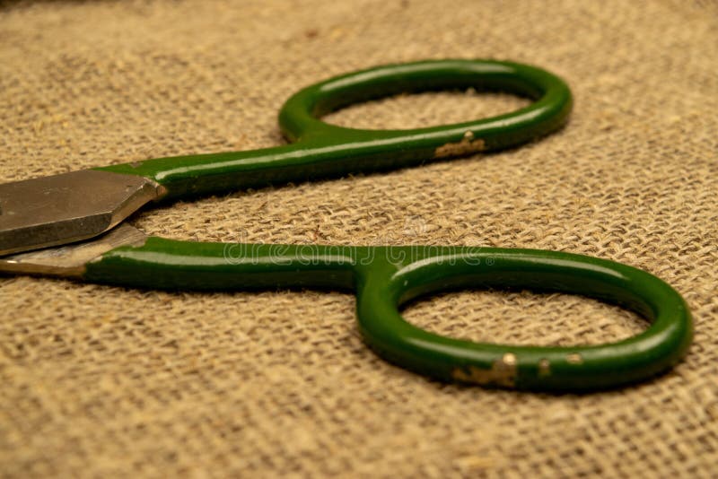Large Vintage Scissors Lie on Rough Homespun Fabric. Close Up Stock