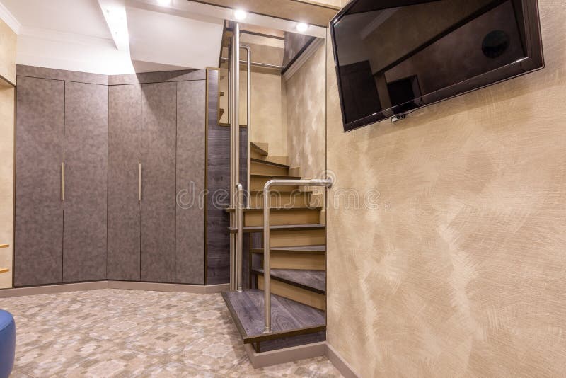 Large wardrobe in the hallway, stairs to the second floor, TV on the wall royalty free stock photography Large wardrobe in the hallway, stairs to the second floor, TV on the wall royalty free stock photography