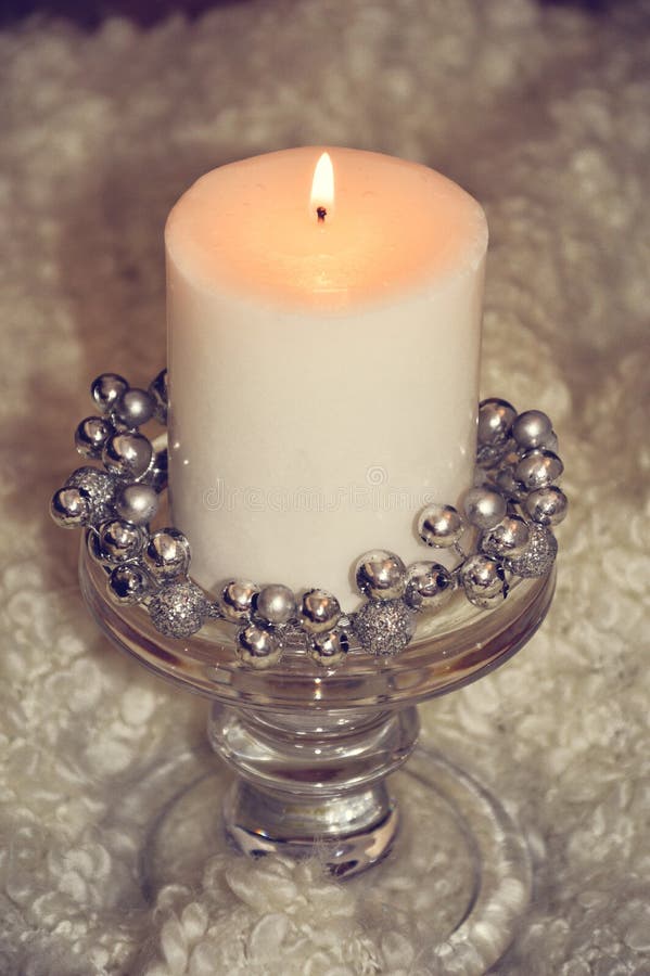 Large White Candle with a Candlestick on a White Background. Stock